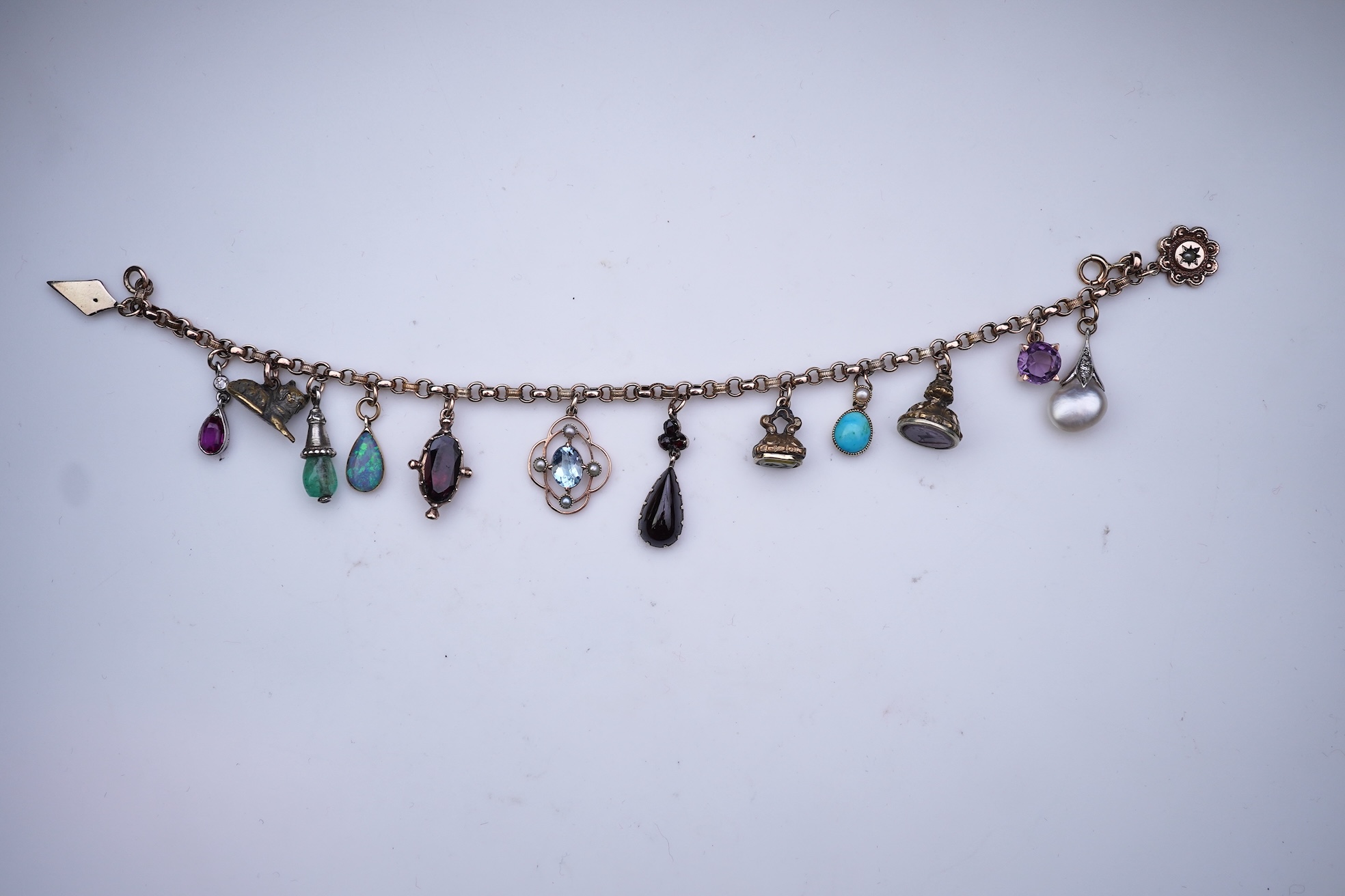 A gem-set charm bracelet, late 19th-early 20th century